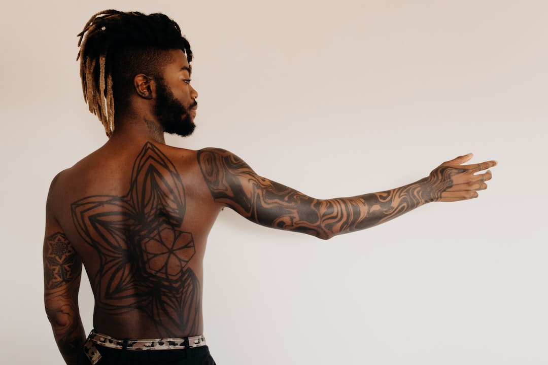 man with geometric pattern tattoo